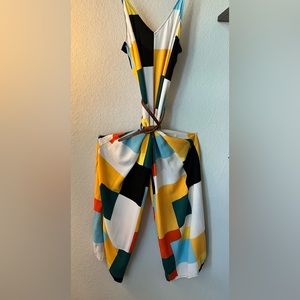 Long, wide leg jumper with adjustable spaghetti straps and a zipper back.